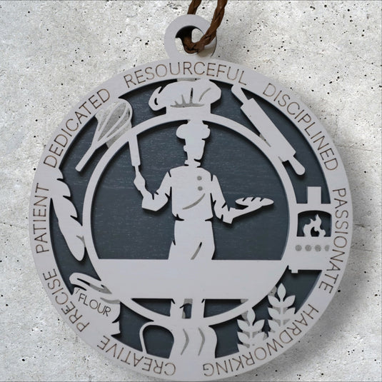 Chef Christmas ornament by Trail and Timber Co. — laser-cut wood, ringed with the words dedicated, disciplined, passionate, precise