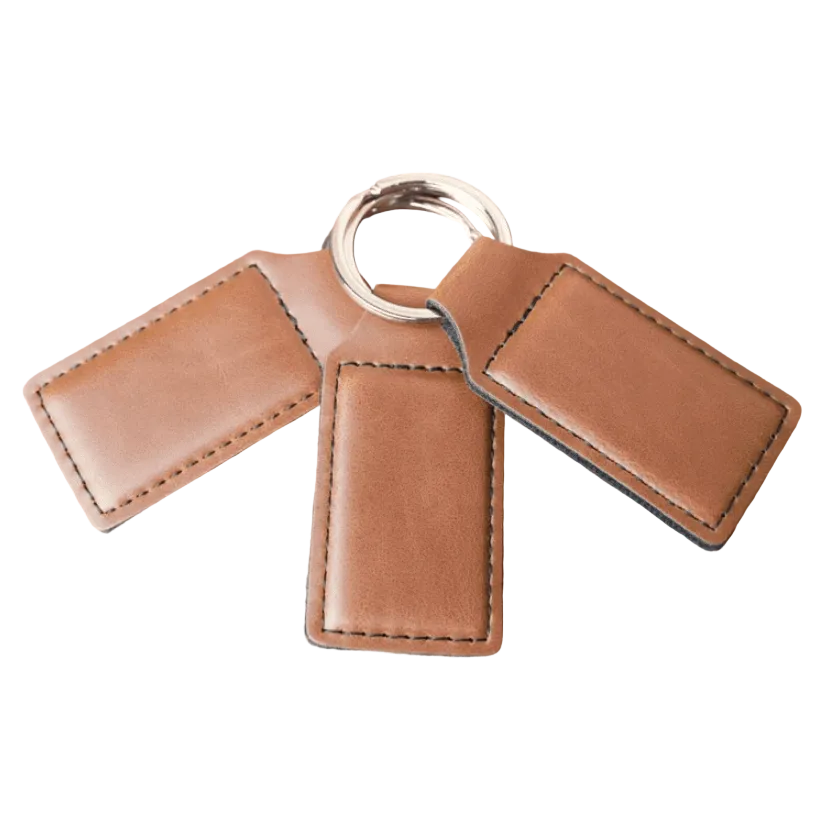 Three tan leatherette keychain tags on a split ring, white background