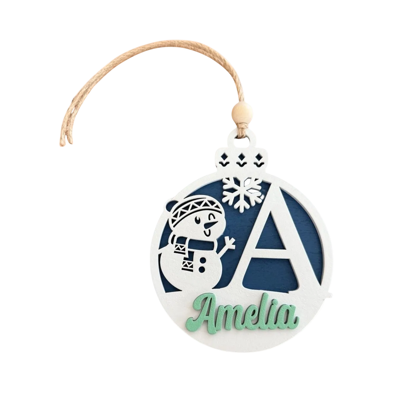 Load image into Gallery viewer, Trail and Timber Co custom wooden Christmas ornament featuring a snowman, snowflake, and letter A with name Amelia.
