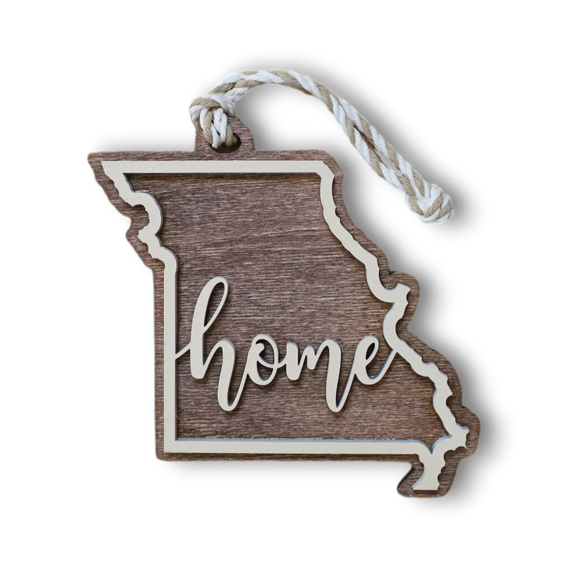 Load image into Gallery viewer, Trail and Timber Co. laser-cut wooden Missouri state ornament with Home inscription and hanging twine
